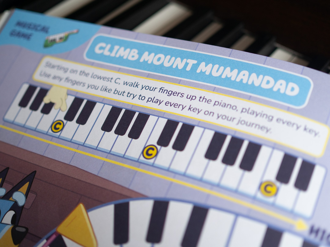 Illustrated game from Bluey: First Ever Piano Book helping children find and play the note C on the piano keyboard.